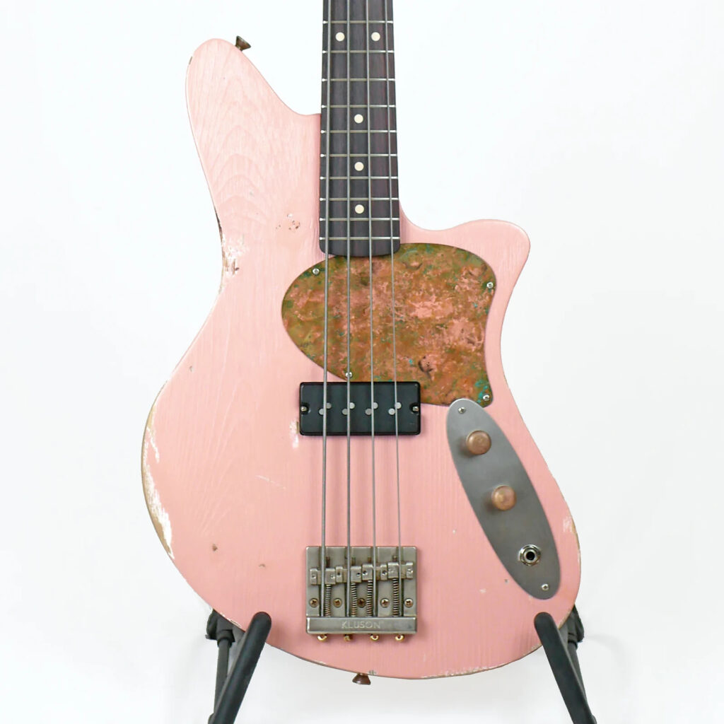 The image shows the front of a 30" short-scale bass in shell pink relic with a Nordstrand Fat Stack pickup.