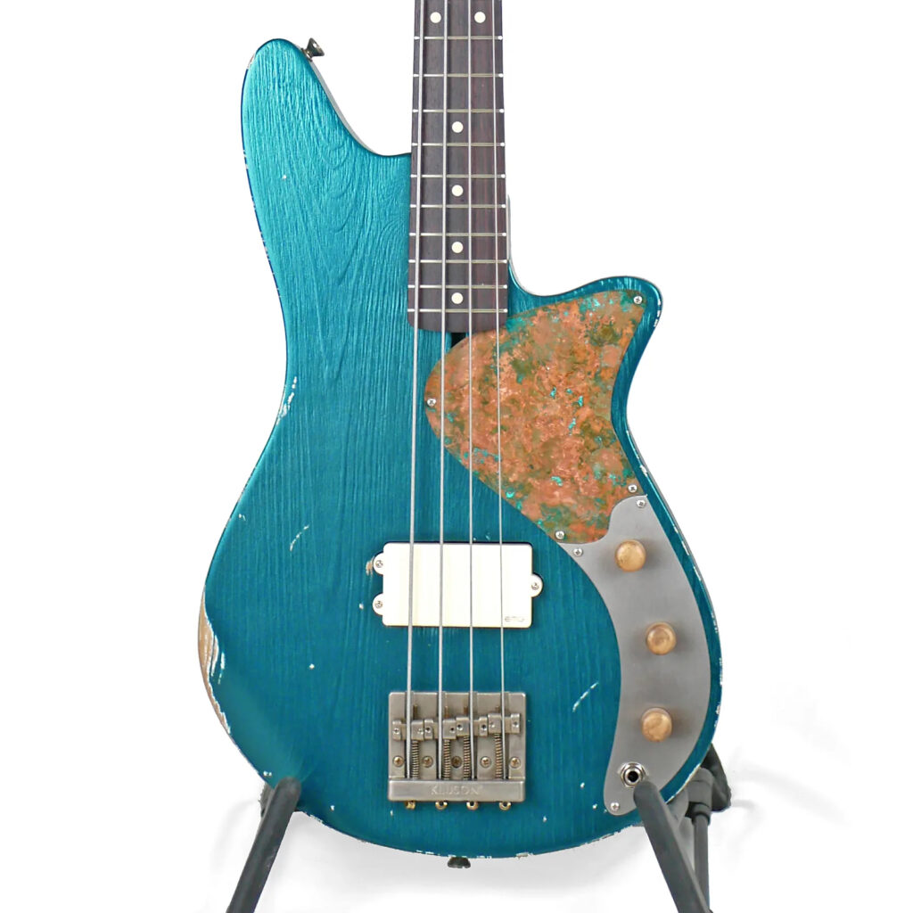Image of a 32" medium-scale bass in Ocean Turquoise Metallic Relic on Distressed Pine with an EMG MMHZ Pickup