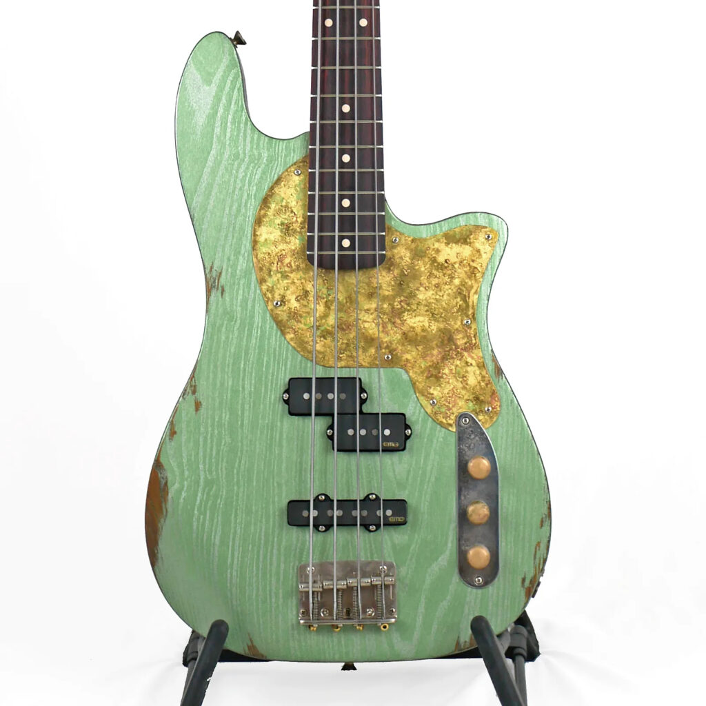 Image is of the front of an Offbeat Guitars Priscilla PJ 34" Long-Scale Bass in Avocado Green Metallic Relic on Distressed Catalpa with EMG Geezer Butler PJ Pickup Set