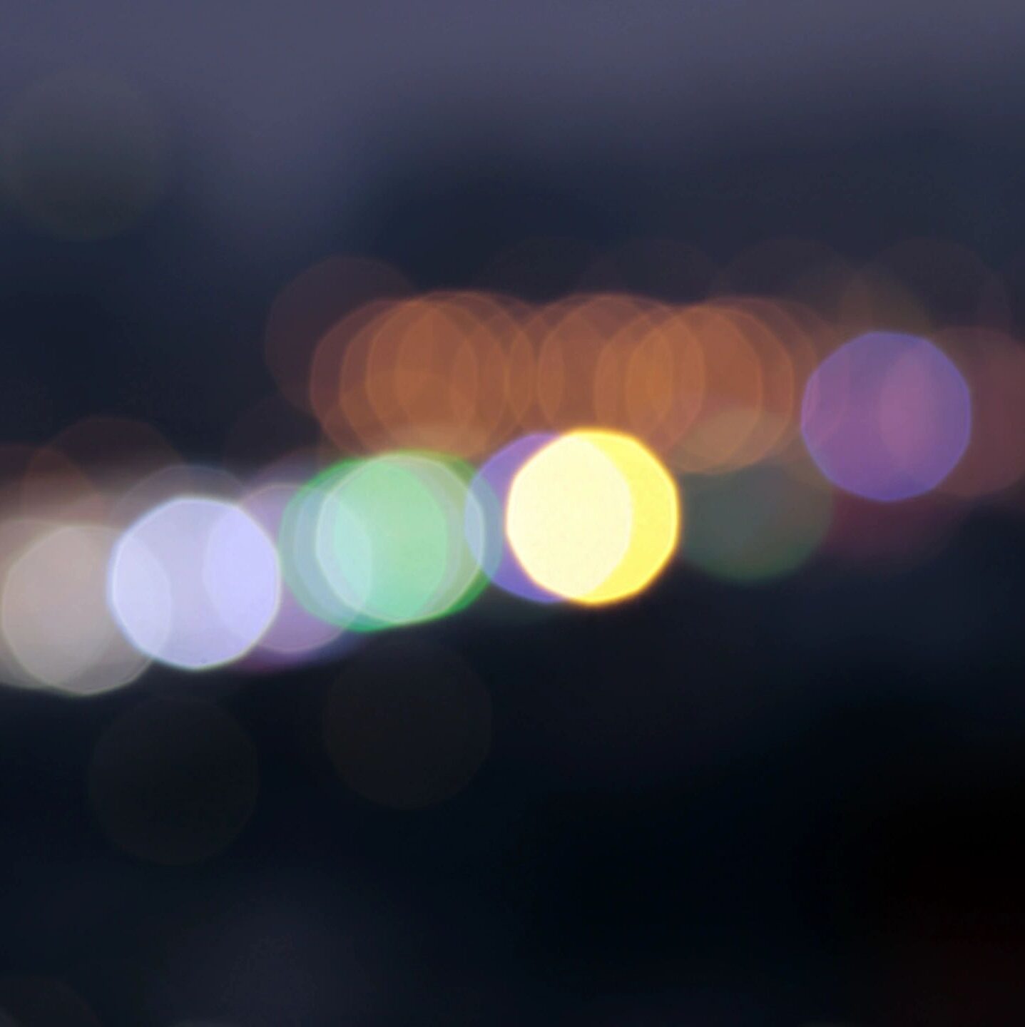 Image is of lights shining in the distance. Clicking on the image will lead to the Sights page.