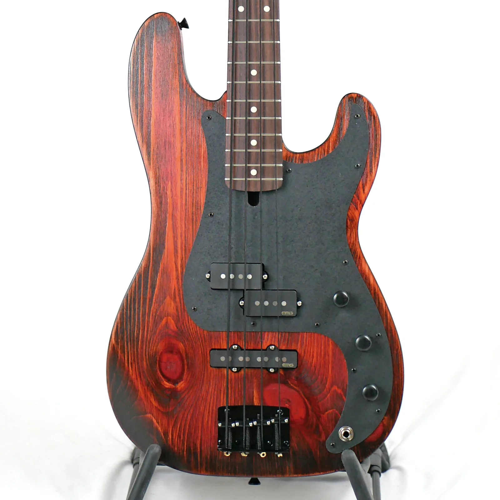 Image is of the front of a Pamela PJ 34" Long-Scale Bass in Tangerine Dream on Distressed Pine with EMG Geezer Butler PJ Pickups