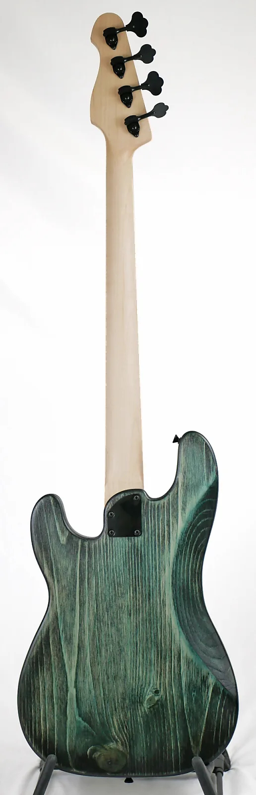 Full length image of the back of a Pamela PJ 34-Inch Long-Scale Bass in Teal Glow on Distressed Pine
